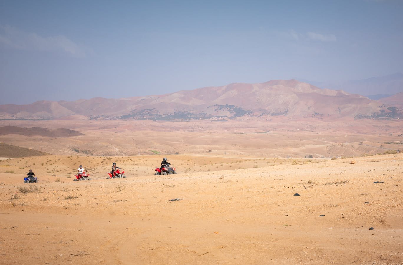 Group of quad bikers exploring the vast Agafay desert near Marrakech, Morocco.