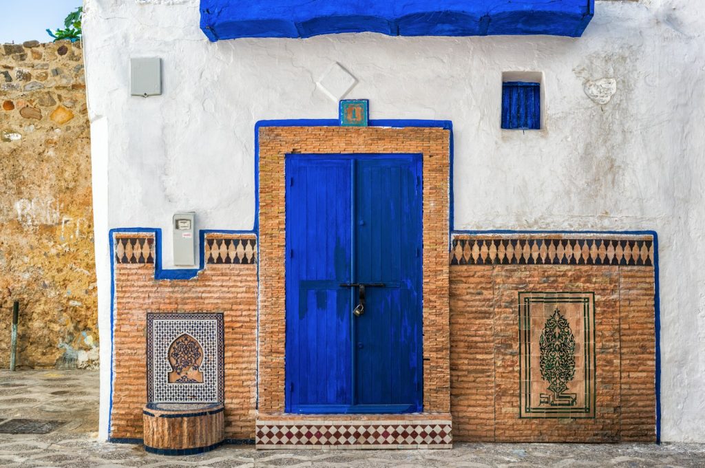 a blue and white building with a blue door